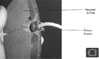 Description de l'image par IA : Radiographie montrant une prothèse d'épaule avec étiquettes "Plaquette de frein" et "Témoin d'usure".